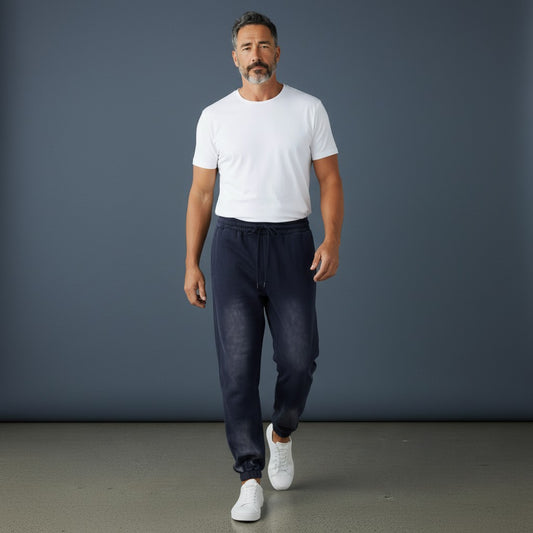 OMINA Studio vintage-inspired heavyweight sweatpants in dark wash denim with a relaxed fit and elastic waistband.