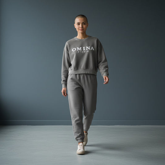 OMINA Studio vintage washed grey cropped sweatshirt with oversized fit and white logo.