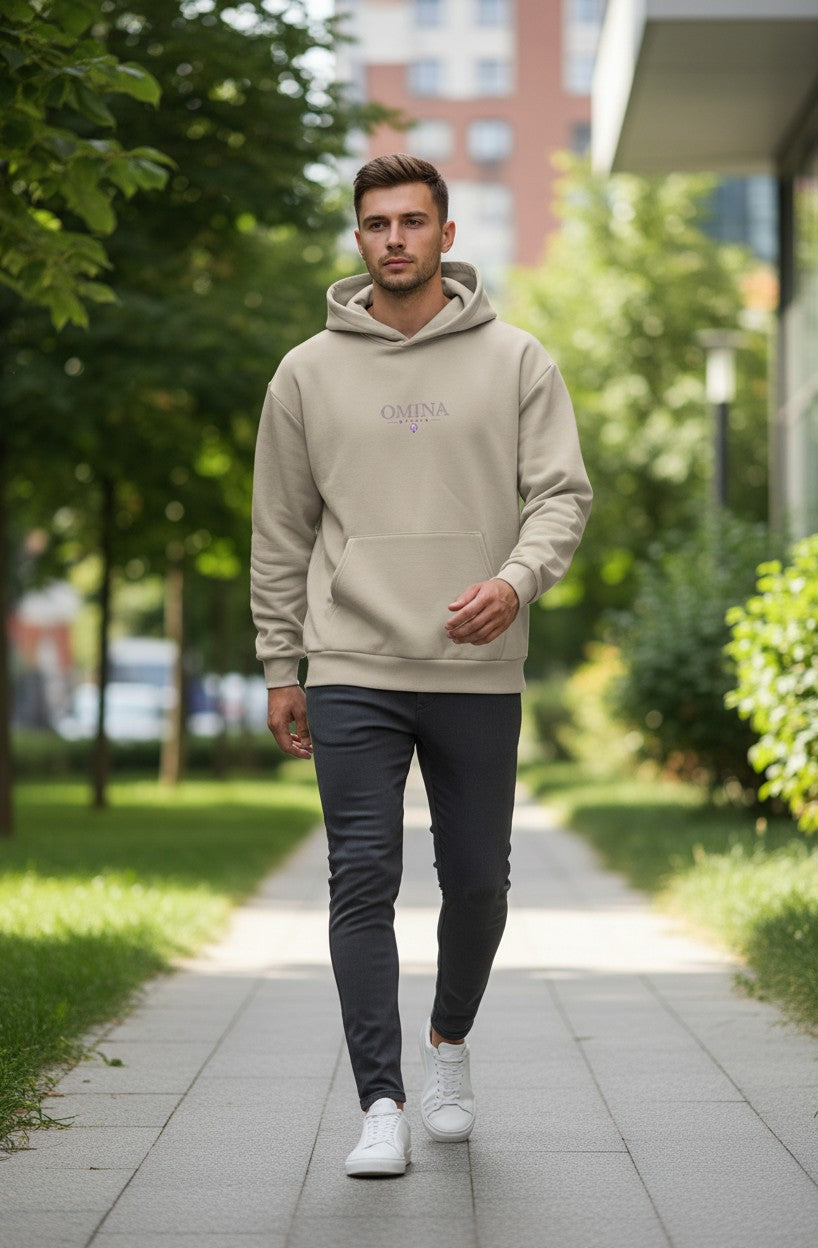 Omina Studio beige heavyweight fleece pullover hooded sweatshirt with minimal branding and kangaroo pocket.