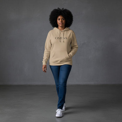 Omina beige pigment-dyed cotton blend hoodie with front logo and oversized back graphic, worn by a woman.