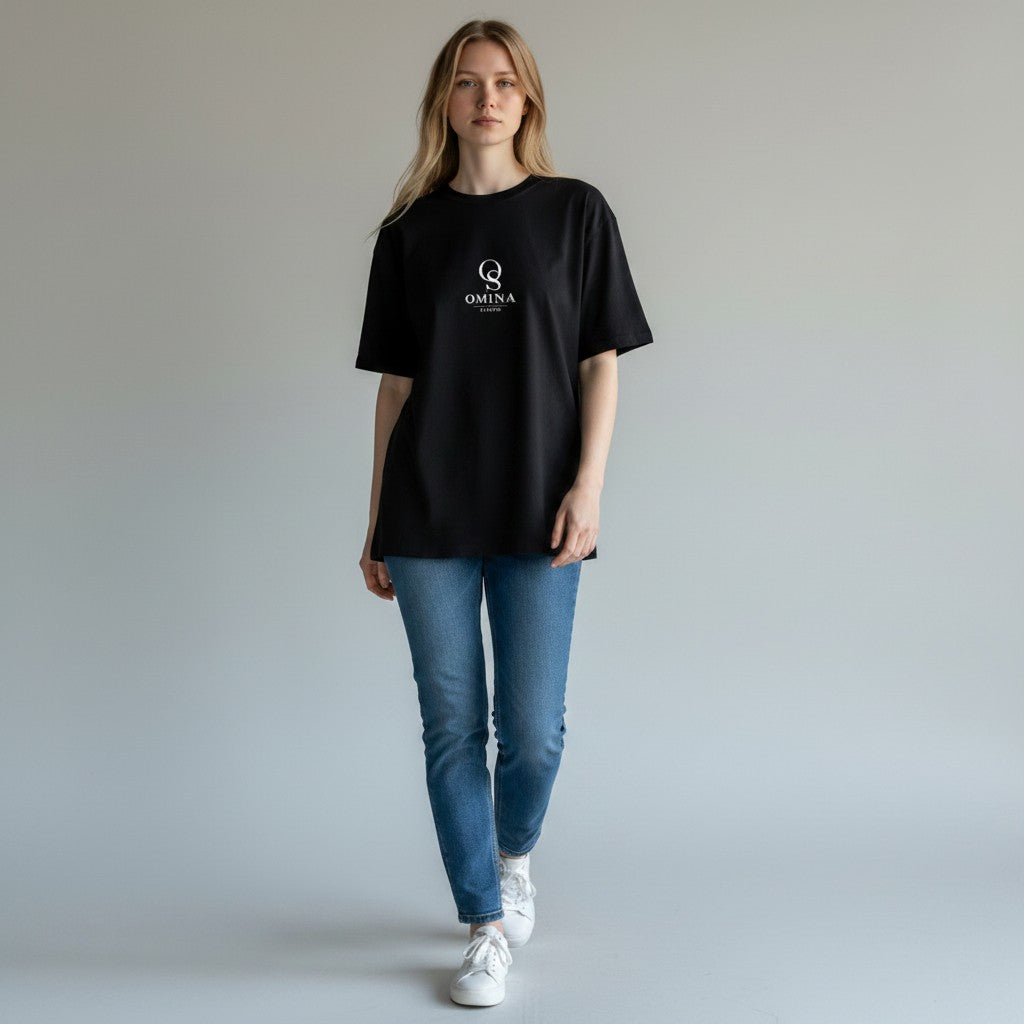 Omina black heavyweight cotton boxy t-shirt with raw edge detailing on a woman wearing blue jeans.