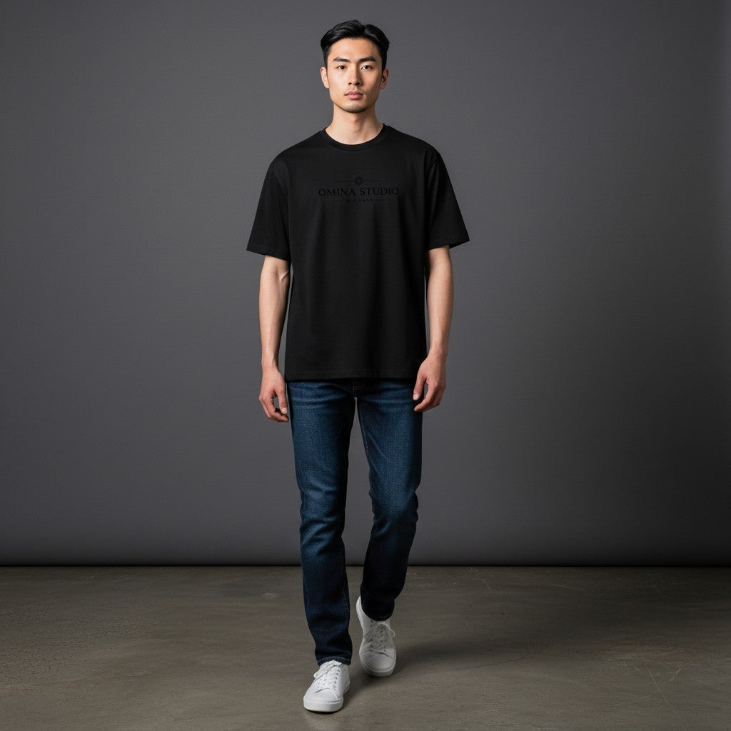 Omina black cotton blend short sleeve crew neck t-shirt with Omina Studio logo print on chest.