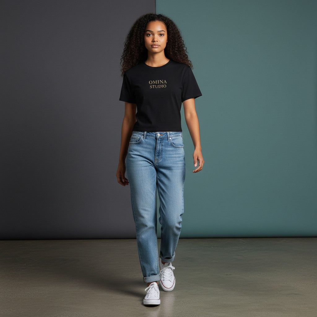 Omina black cotton-spandex blend crewneck t-shirt with "OMINA STUDIO" logo on chest. Cropped fit.