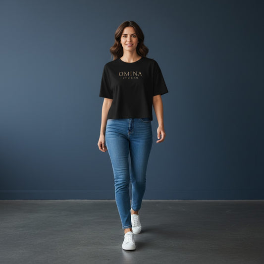 Omina Studio black 100% cotton crop top with oversized sleeves and relaxed fit, featuring a gold Omina Studio logo on the chest.