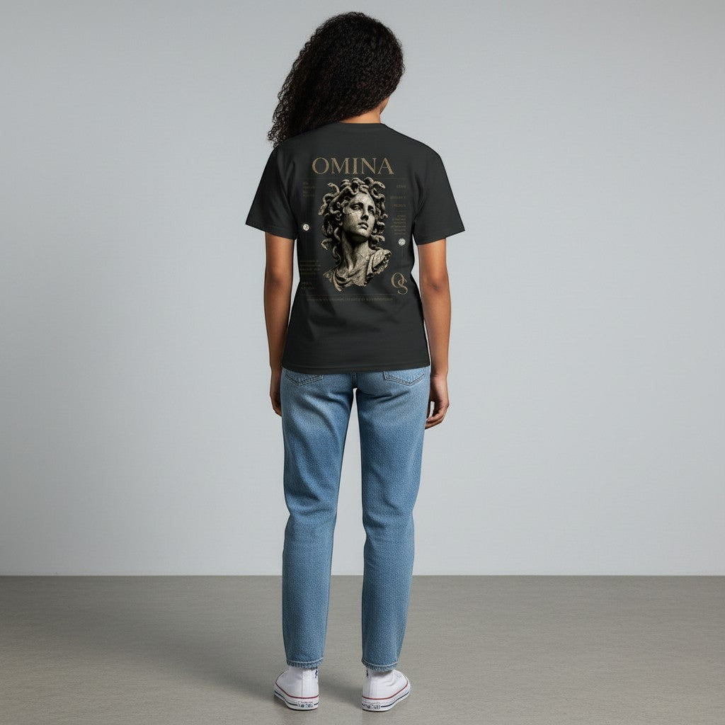 Omina Studio black cotton t-shirt with a graphic of a classical bust and text on the back. Model wears light wash jeans and white sneakers.