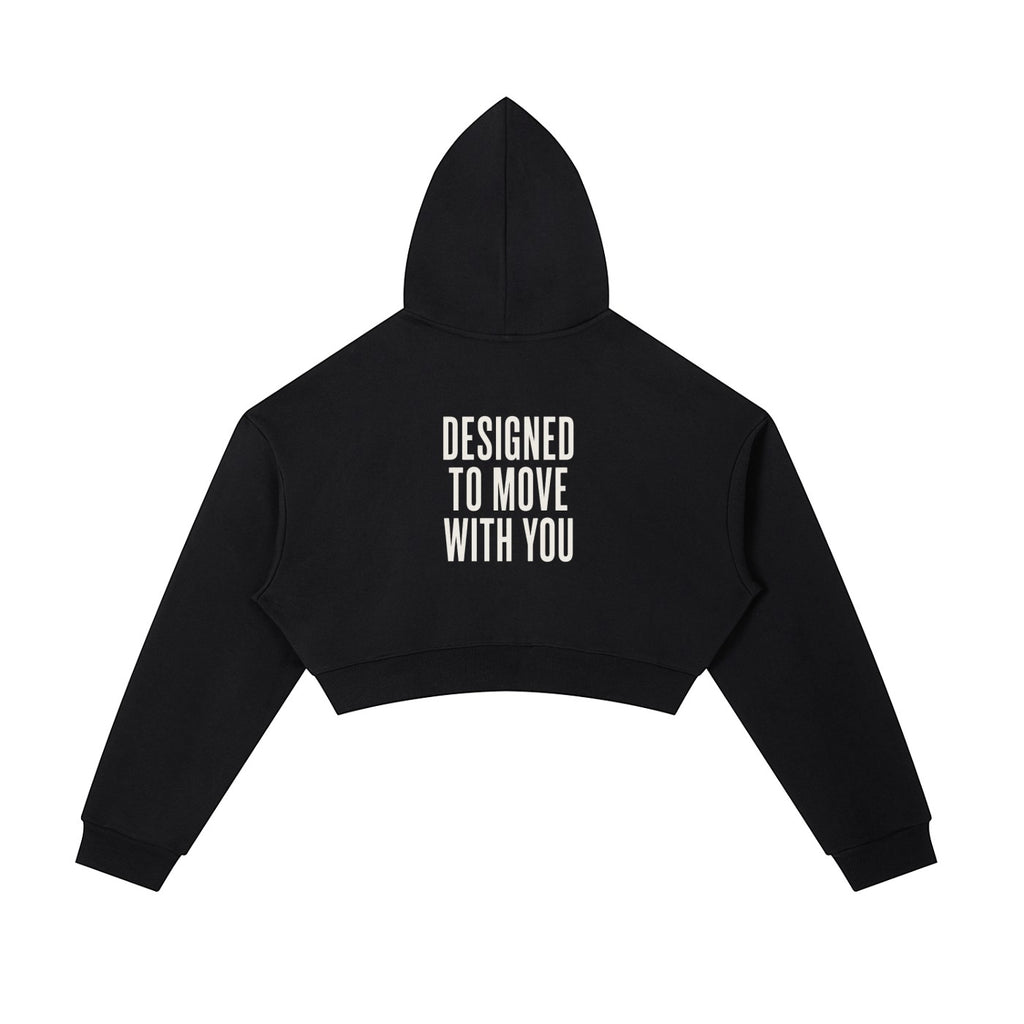 Omina black cotton blend cropped zip-up hoodie with adjustable drawstring hood and "DESIGNED TO MOVE WITH YOU" text on back.