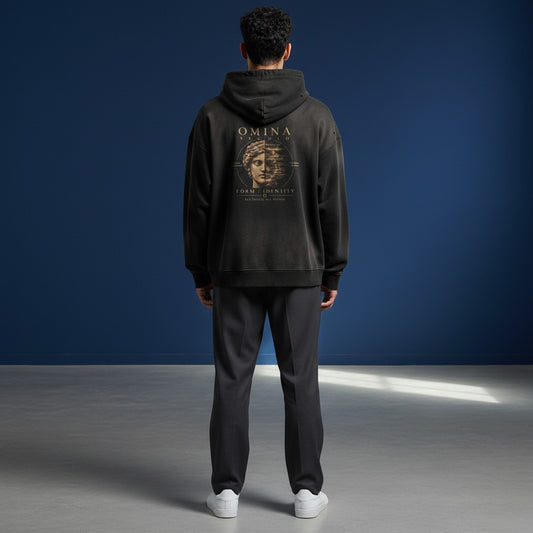 Omina Studio black faded graphic hoodie with a distressed, art-forward design featuring a split Roman bust and text.