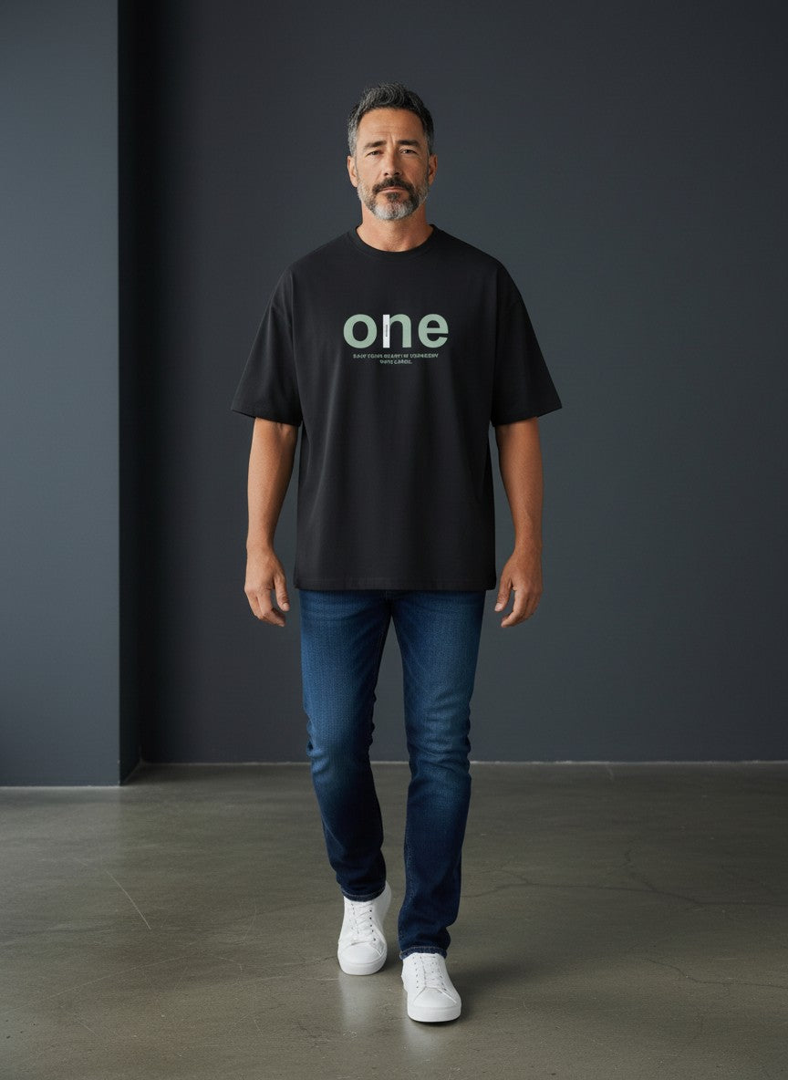 Omina black cotton-spandex blend oversized t-shirt with a large light green 'one' graphic and smaller text below.