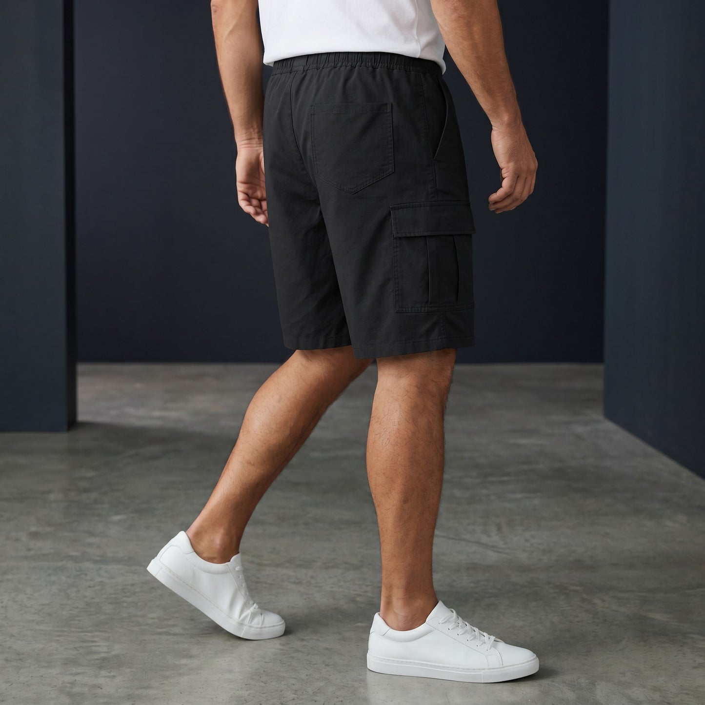 Omina black polyester unisex cargo shorts with elastic waistband and drawstring, featuring functional cargo pockets.