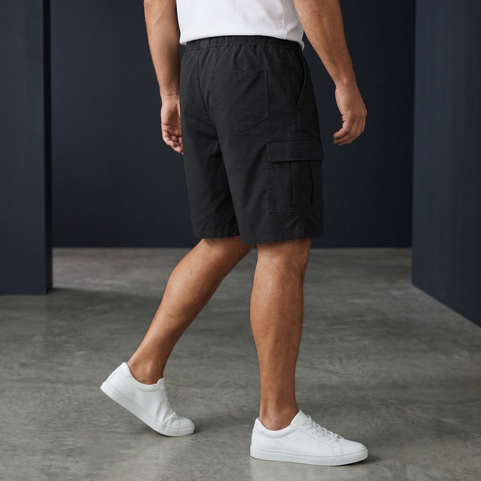Omina black polyester unisex cargo shorts with elastic waistband and drawstring, featuring functional cargo pockets.