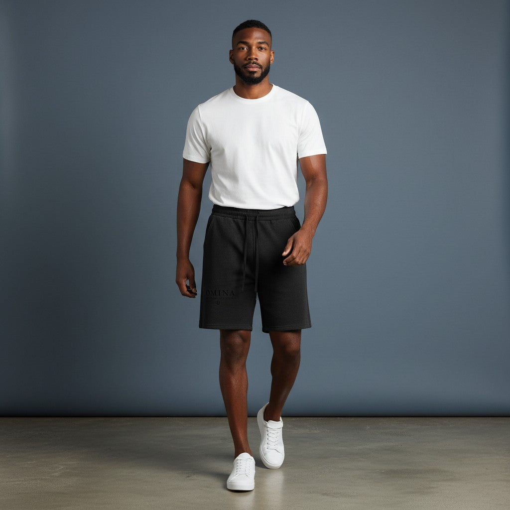 Omina black mineral wash waffle knit shorts with elastic waistband and drawstring. Relaxed fit, textured fabric.