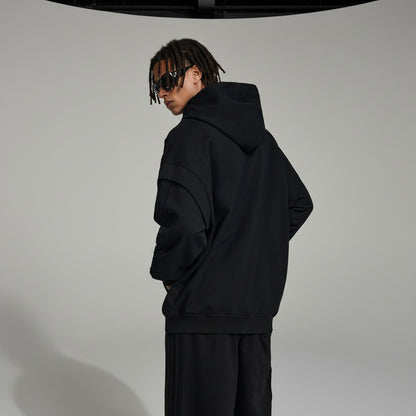 Omina black cotton-blend zip hoodie with raw edge detailing and contrast tape accents. Oversized fit.