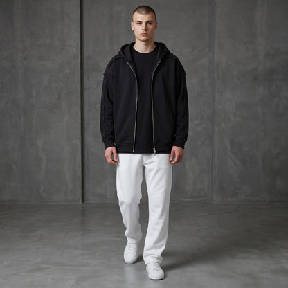 Omina black cotton-blend zip-up hoodie with raw edge detailing and contrast tape accents. Oversized fit.