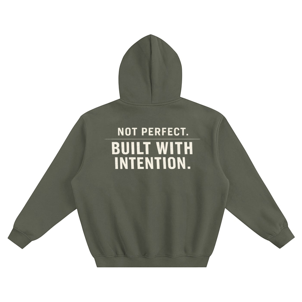 Omina olive green fleeced boxy hoodie with "NOT PERFECT. BUILT WITH INTENTION." graphic on back.