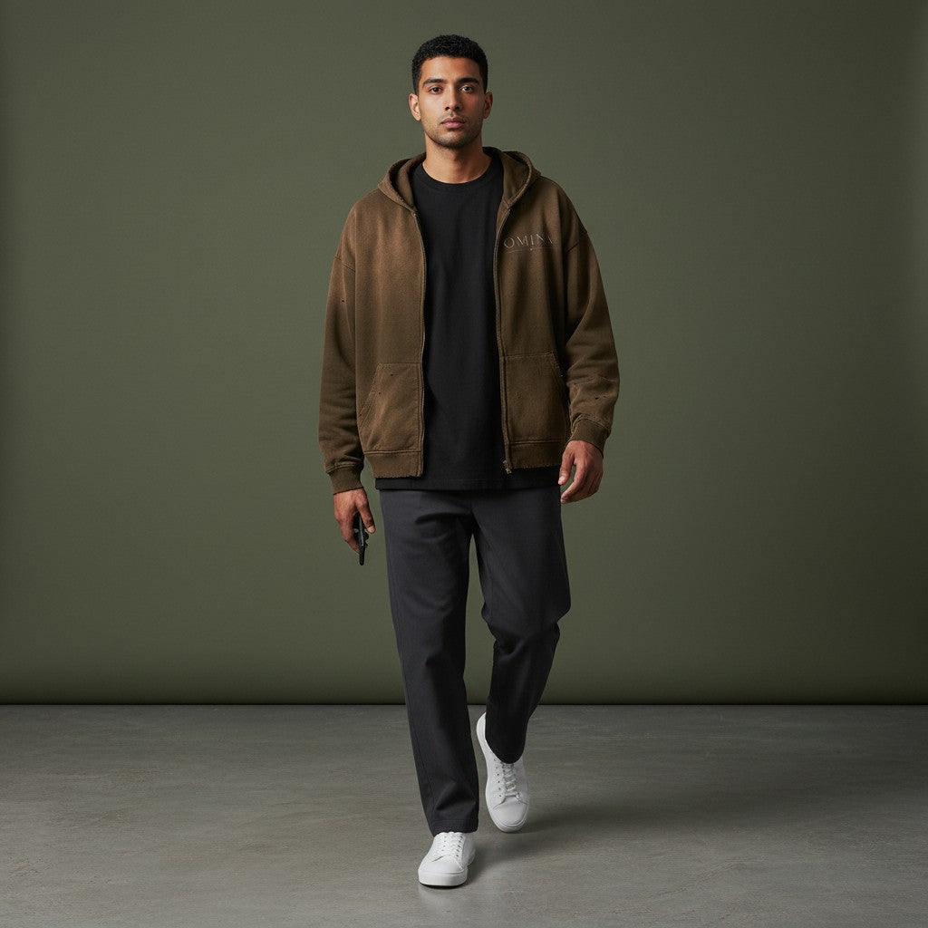 Omina Studio brown distressed zip-up hoodie with faded graphic and front pockets. Streetwear style.