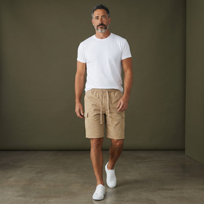 Omina beige polyester cargo shorts with drawstring elastic waistband and functional side pockets. Relaxed unisex fit.