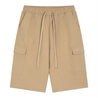 Omina beige polyester cargo shorts with drawstring elastic waistband and functional side pockets. Relaxed unisex fit.