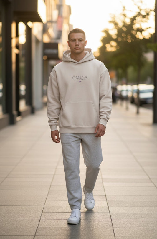 Omina Studio cream heavyweight fleece pullover hooded sweatshirt with kangaroo pocket and subtle logo.