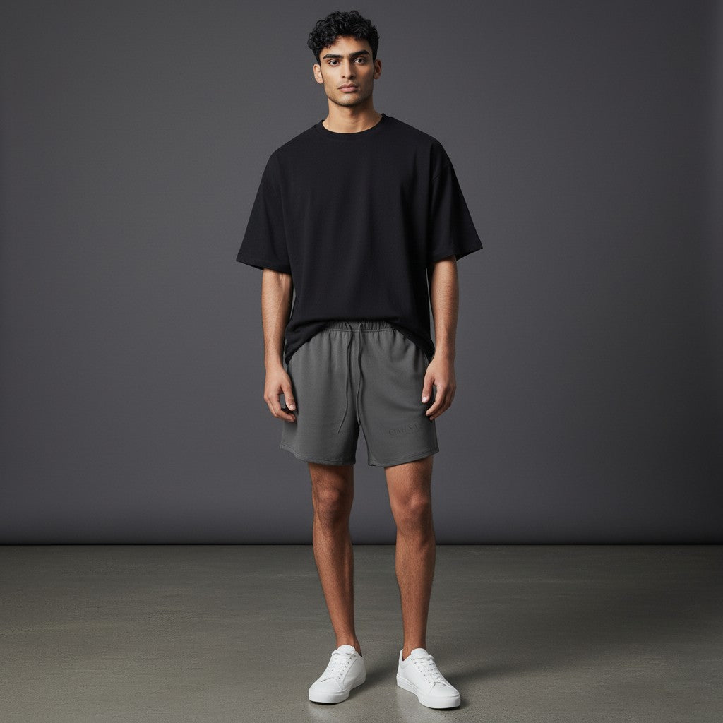 Omina Studio dark grey relaxed fit athletic shorts with drawstring and subtle logo detail.
