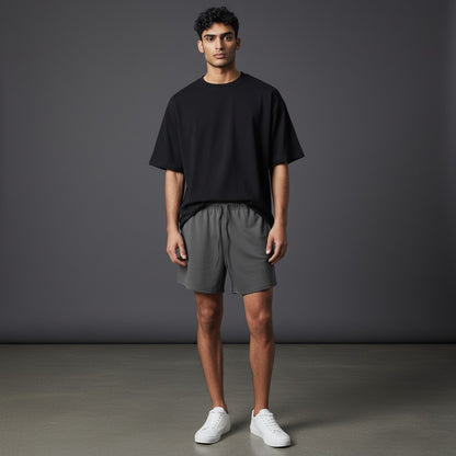 Omina Studio dark grey relaxed fit athletic shorts with drawstring and subtle logo detail.