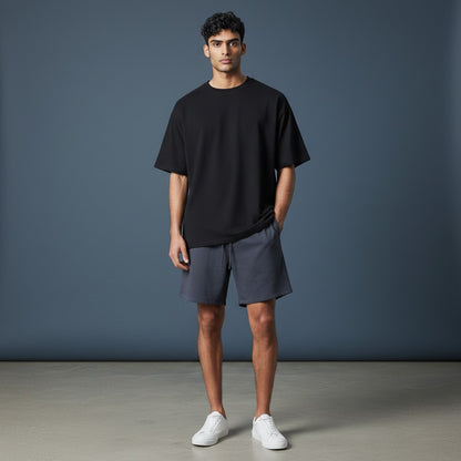 Omina Studio dark grey relaxed fit athletic shorts with drawstring and subtle logo detail.