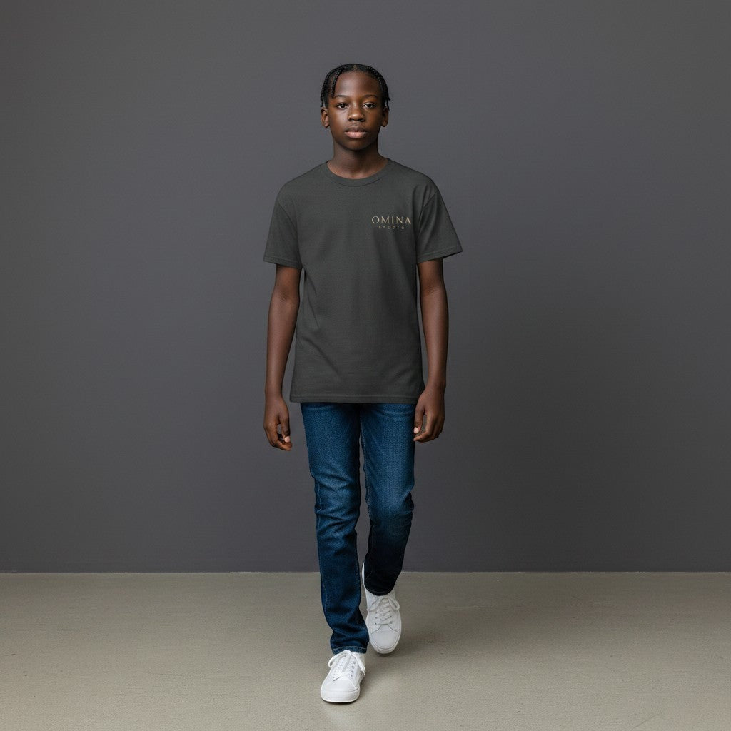 OMINA Studio dark grey premium cotton t-shirt with minimalist logo on chest, worn by a young boy.