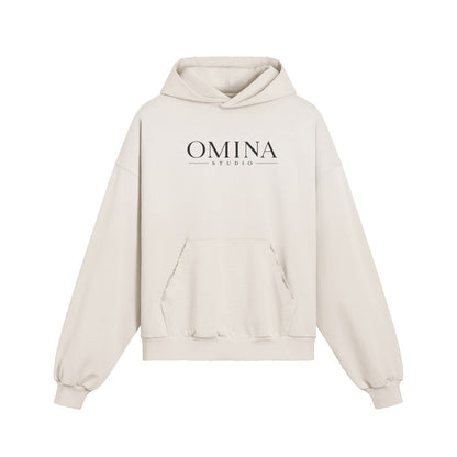 Omina oversized distressed cream cotton hoodie with frayed details and front pocket. Boxy fit with drop shoulders.