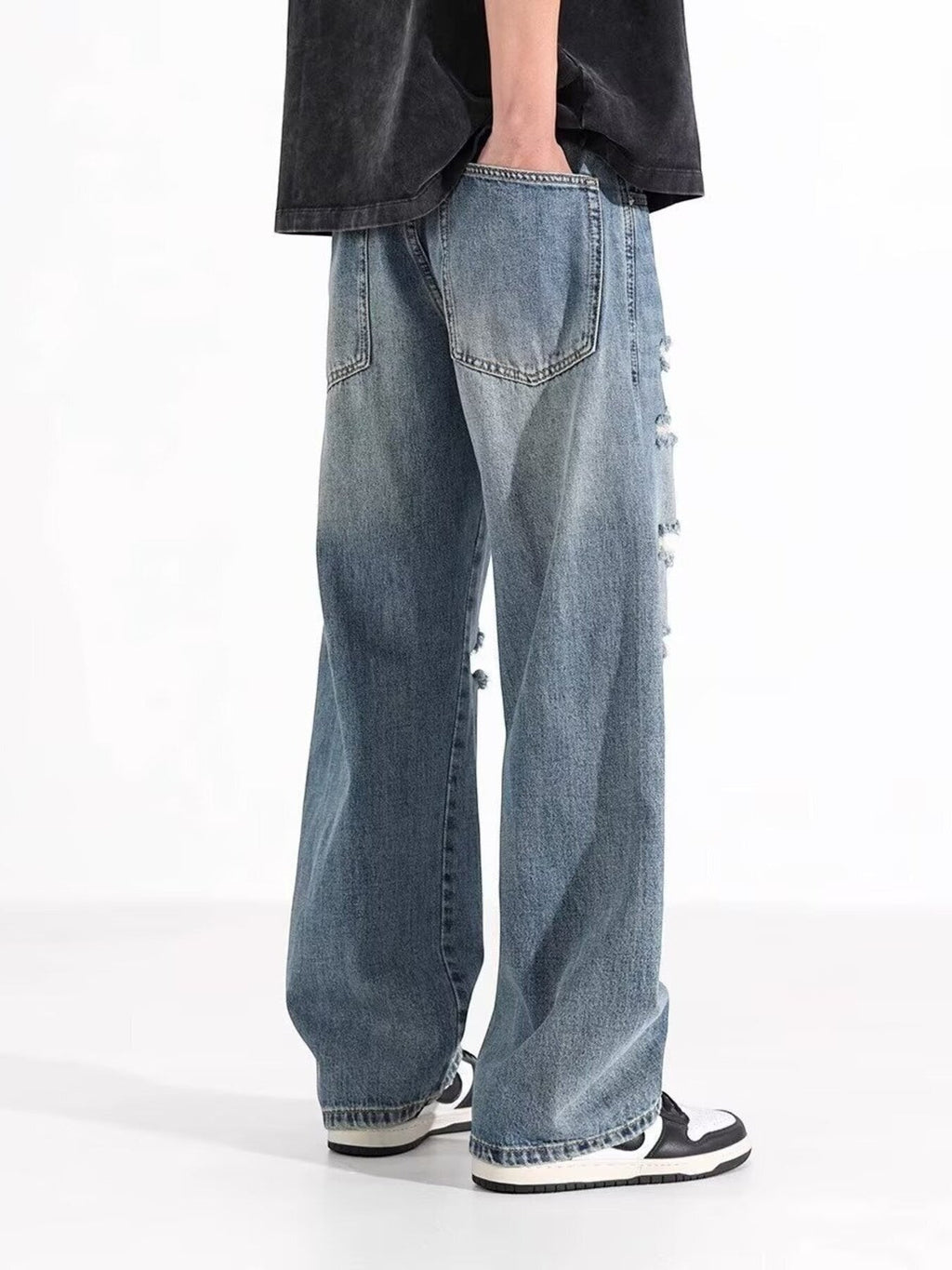 Omina blue wash distressed wide leg denim jeans with a relaxed fit and edgy vibe.