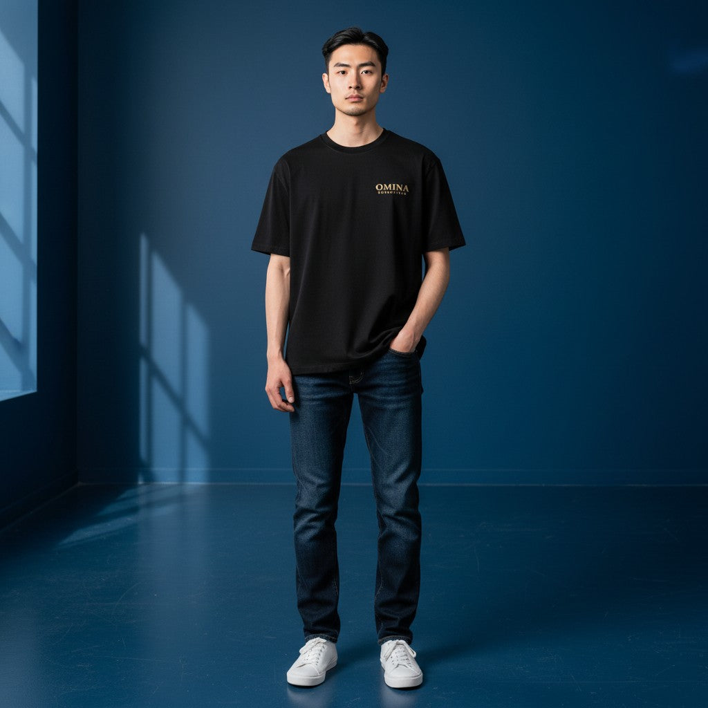 OMINA ESSENTIALS black heavyweight cotton t-shirt with oversized fit and drop shoulders. Minimalist streetwear style.