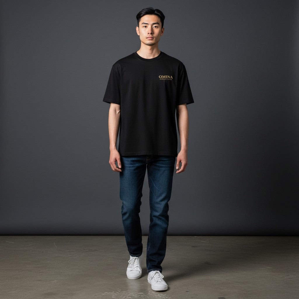 OMINA ESSENTIALS black heavyweight cotton t-shirt with oversized fit and drop shoulders. Minimal logo on chest.
