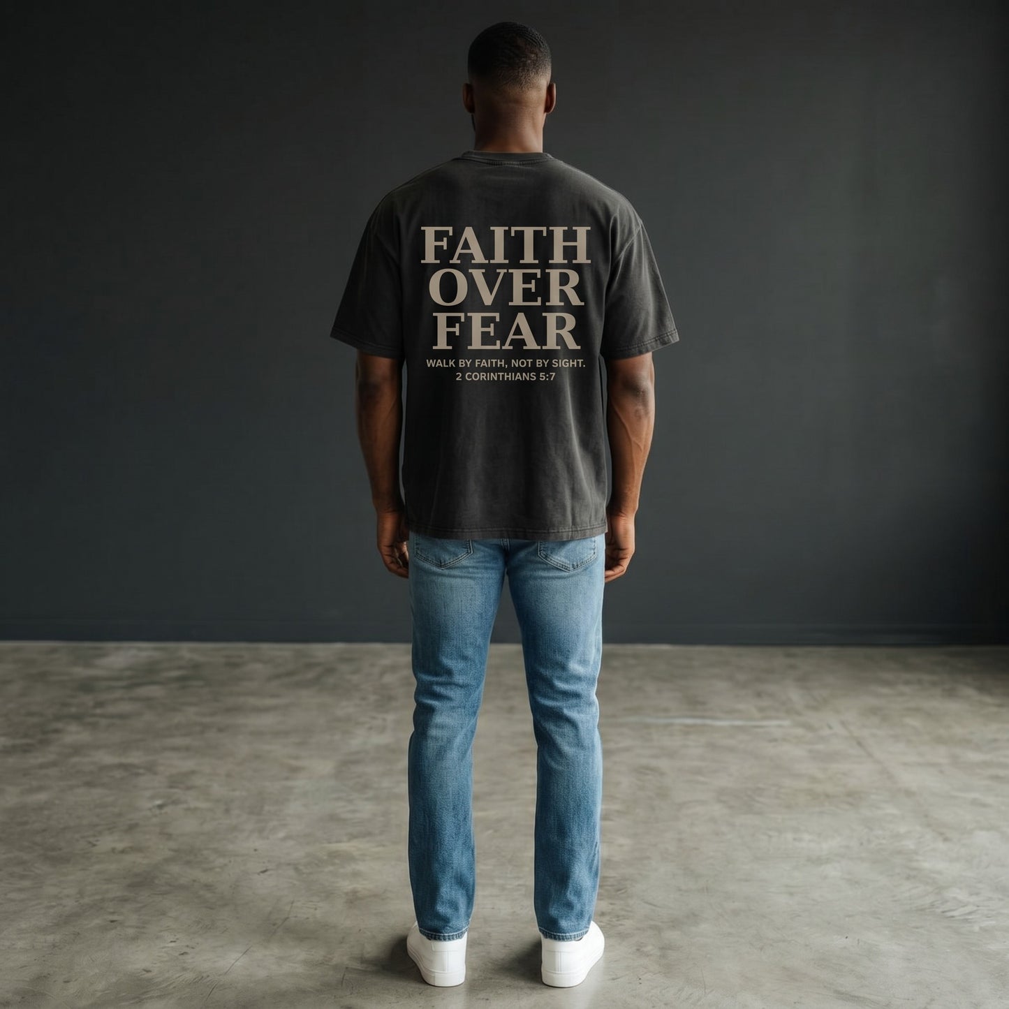 OMINA Studio black heavyweight cotton t-shirt with "FAITH OVER FEAR" graphic and Bible verse 2 Corinthians 5:7.