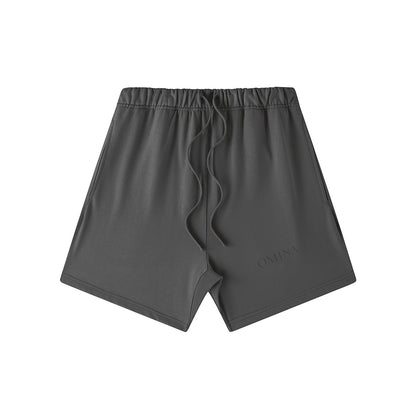 Omina Studio charcoal grey heavyweight French terry shorts with drawstring waist and subtle logo detail.