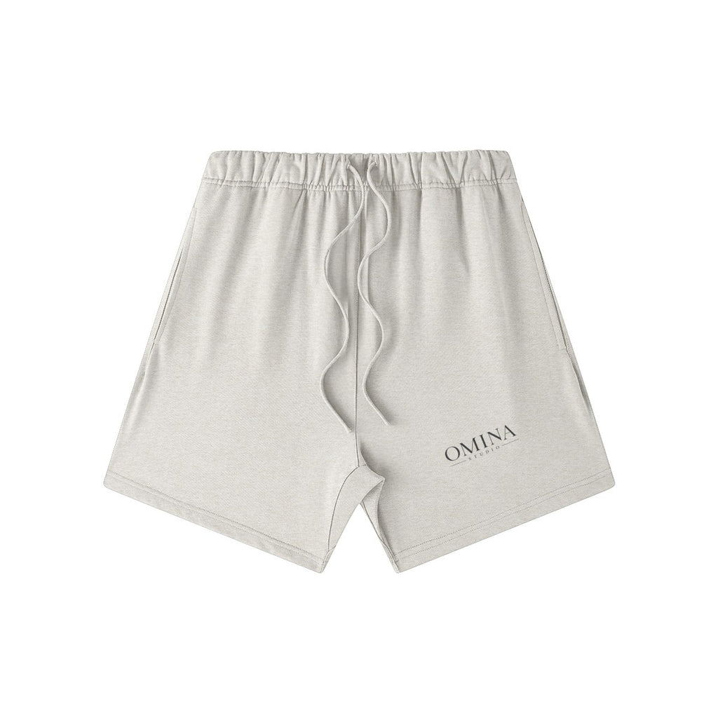 Omina Studio light grey heavyweight French terry shorts with drawstring and subtle logo detail.