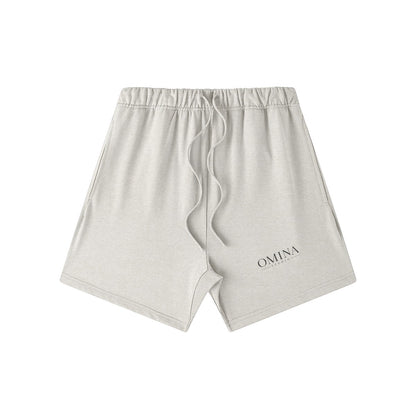 Omina Studio light grey heavyweight French terry shorts with drawstring and subtle logo detail.