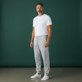 Omina Studio light grey heavyweight cotton blend sweatpants with elastic waistband, drawcord, side pockets, and subtle vertical logo.