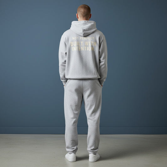 Omina grey fleeced boxy hoodie with "NOT PERFECT BUILT WITH INTENTION" graphic on back. Heavyweight cotton blend.