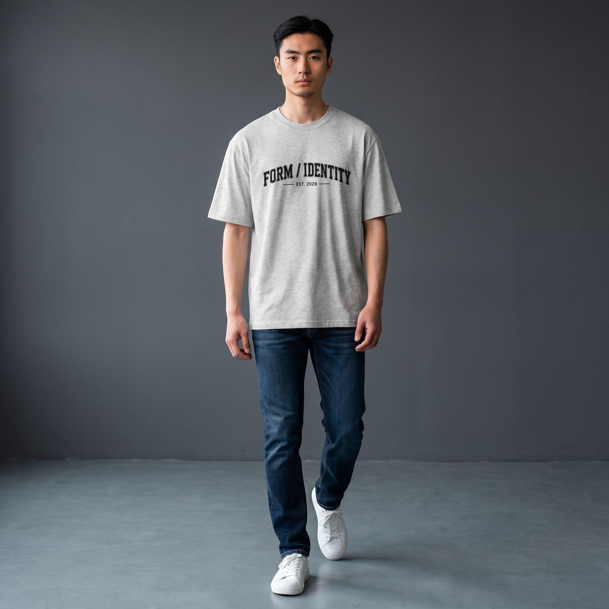 OMINA Studio grey heavyweight cotton t-shirt with "FORM / IDENTITY EST. 2026" graphic on front. Oversized fit.