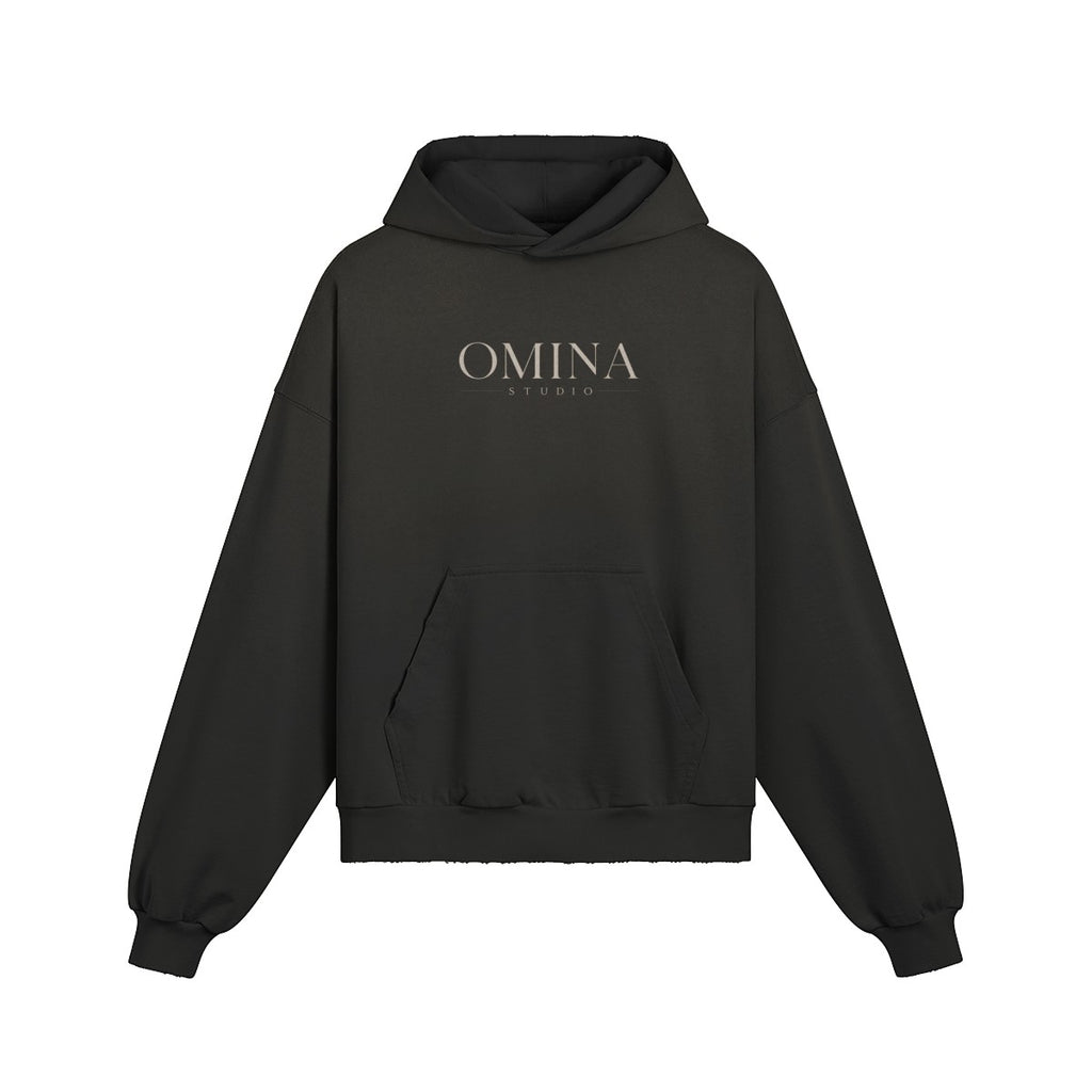 OMINA Studio heavyweight black cotton hoodie with kangaroo pocket and minimalist front logo.