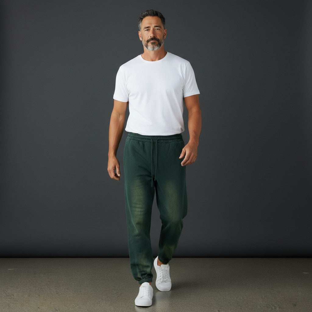 OMINA Studio vintage-inspired heavyweight fleece sweatpants in dark green with a washed finish and adjustable drawstrings.