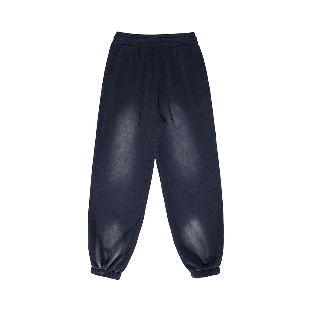 Omina Studio vintage-inspired heavyweight sweatpants in washed navy blue fleece with elastic waistband and drawstrings.