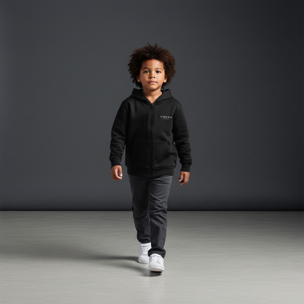 Omina Studio black cotton blend kids zip-up hoodie with kangaroo pockets and minimalist logo.