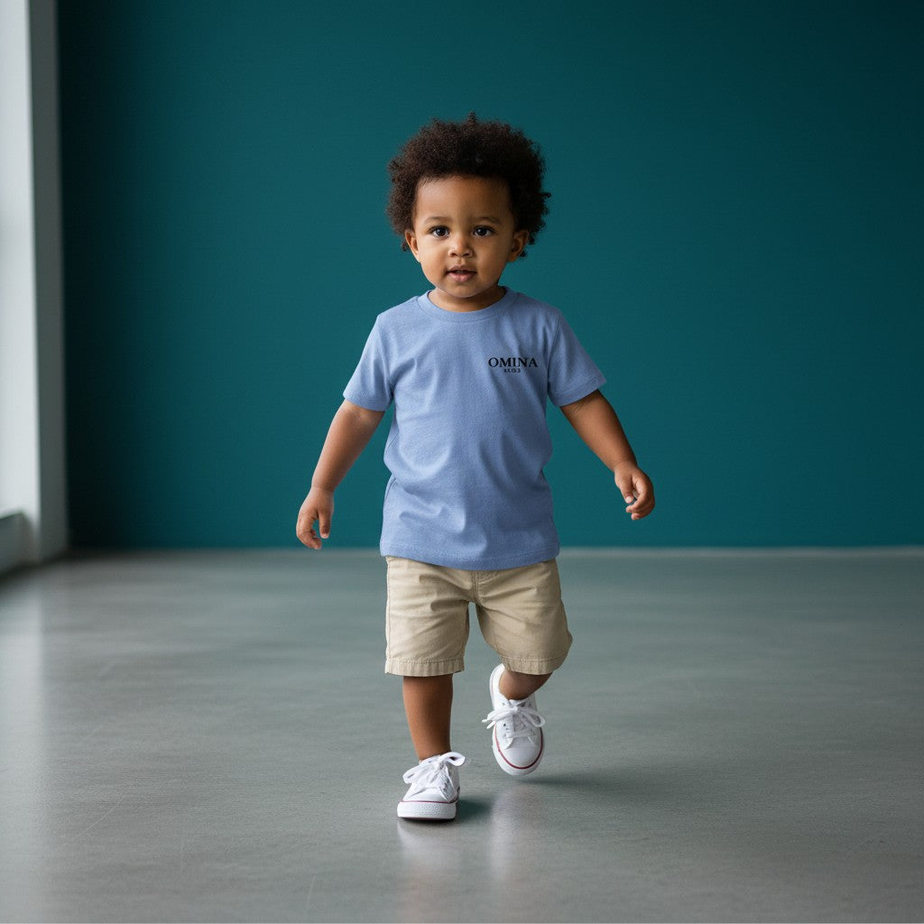 Omina Kids toddler tee in light blue triblend fabric with black Omina Kids logo on left chest. Short sleeves, crew neck.