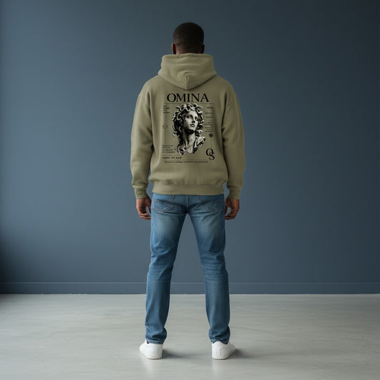 Omina Studio olive green hoodie with a Medusa bust graphic, representing transformation and strength. Features classical marble-inspired artwork.