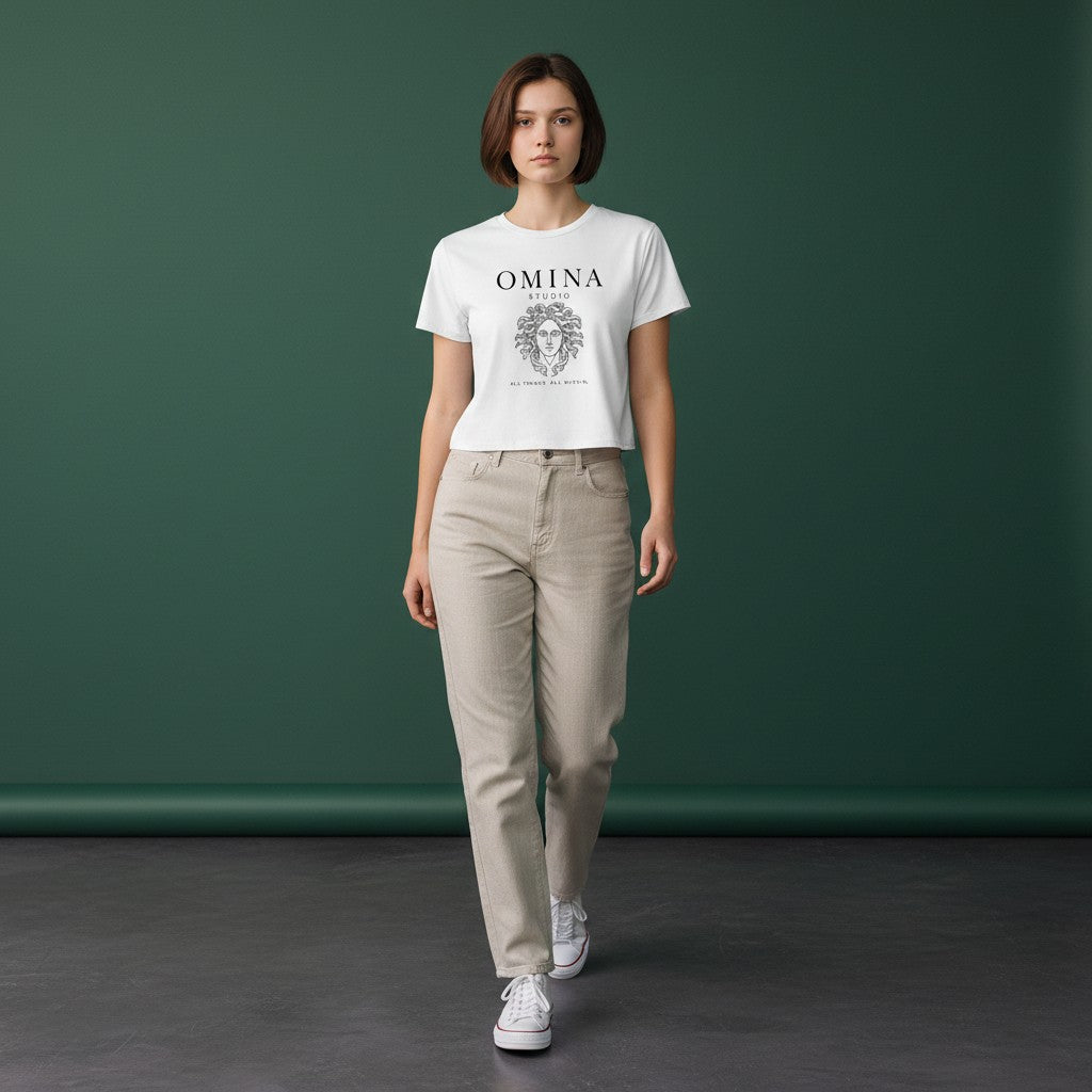 Omina Studio white cotton crop top with black Medusa graphic and text "All Things, All Within."