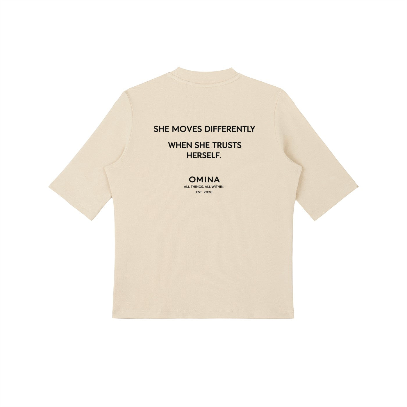 Omina cream mock neck short sleeve t-shirt with "SHE MOVES DIFFERENTLY WHEN SHE TRUSTS HERSELF." graphic.