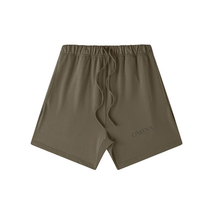 Omina Studio olive green heavyweight French terry shorts with drawstring and subtle logo detail.