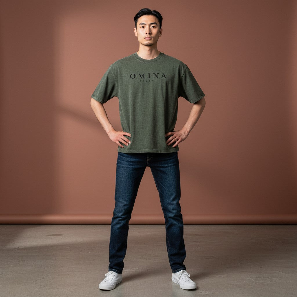 Omina Studio olive green mineral wash cotton t-shirt with black minimalist logo graphic on chest.