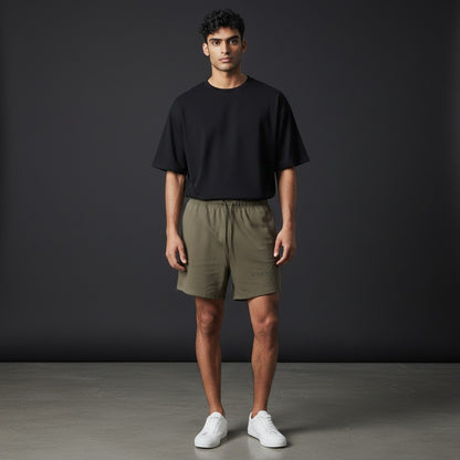 Omina Studio olive green relaxed fit athletic shorts with drawstring waist and subtle logo.
