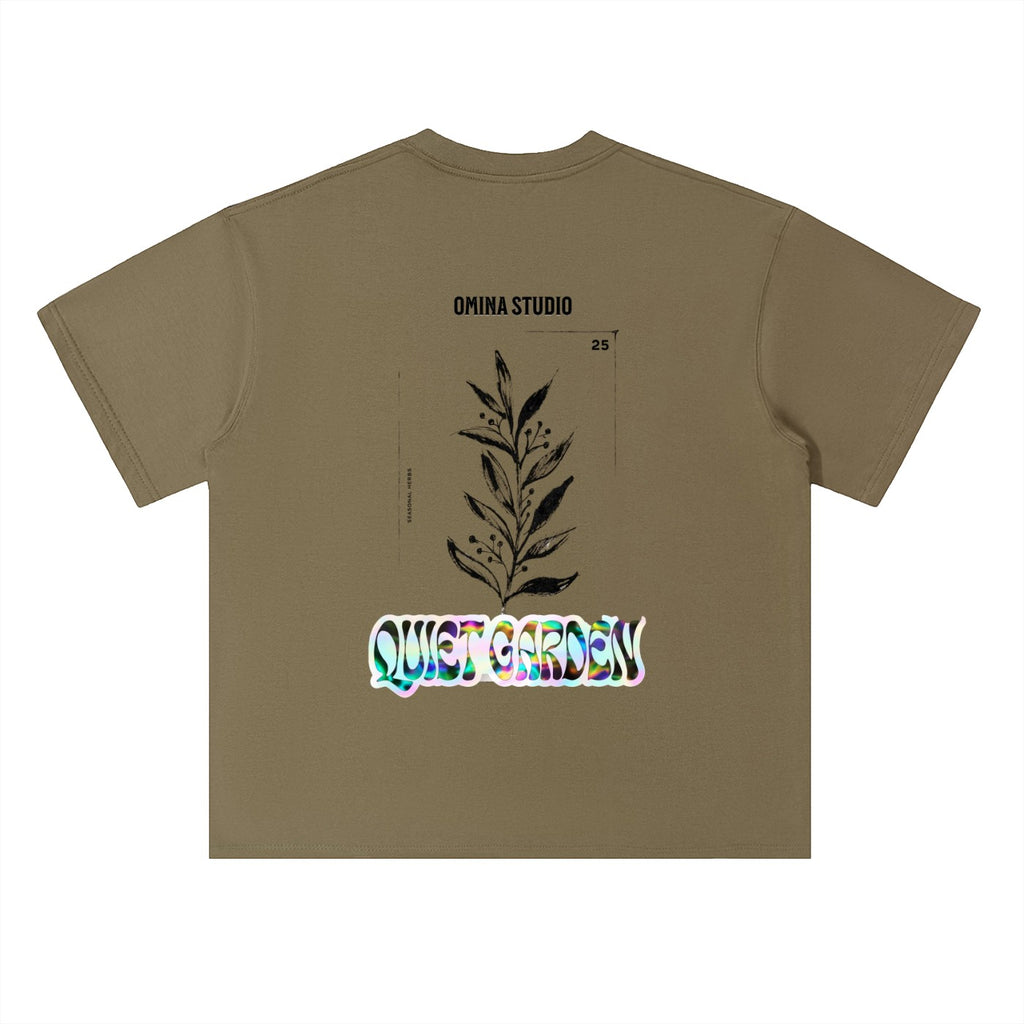 Omina Studio heavyweight cotton t-shirt in olive green with drop shoulders and a graphic print of a plant and "Quiet Garden" text.