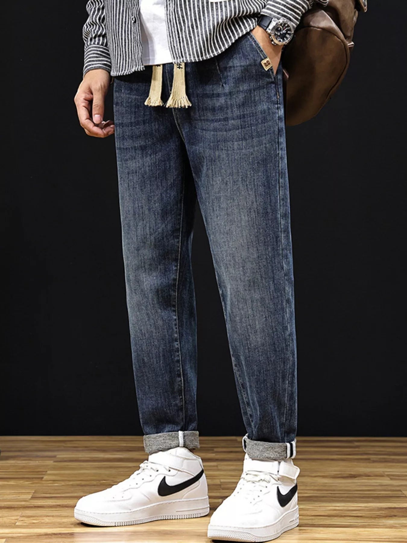Omina relaxed fit blue denim trousers with drawstring waist and utility pockets, cuffed hem.